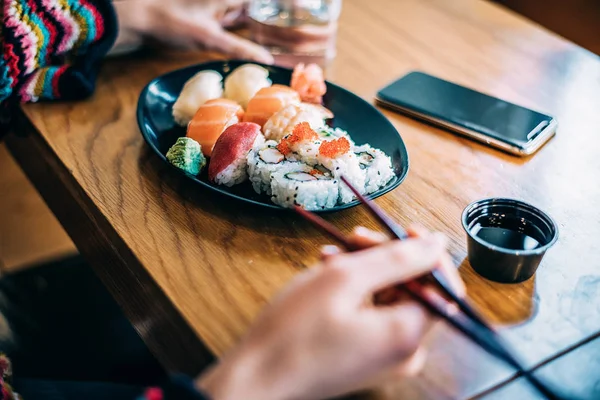 Crop Woman Eating Sushi Background — Stock Photo, Image