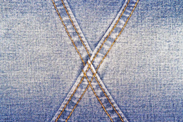 Blue Jeans Textur Hintergrund und Kreuz orange Naht — Stockfoto