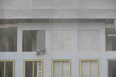 İki kişi sıvama inşaat işçisi abseiling