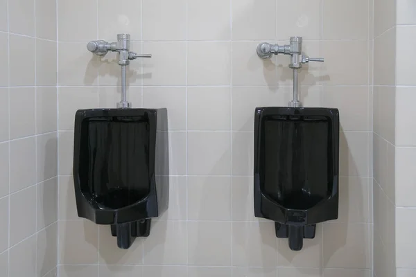 Black urinal of men with tile wall — Stock Photo, Image