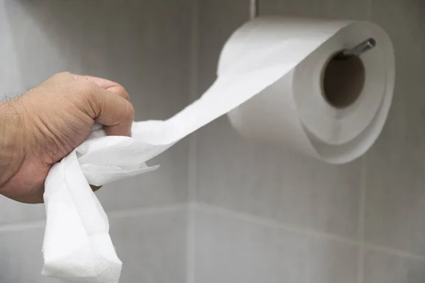 Papel higiénico recogido a mano en el baño . — Foto de Stock