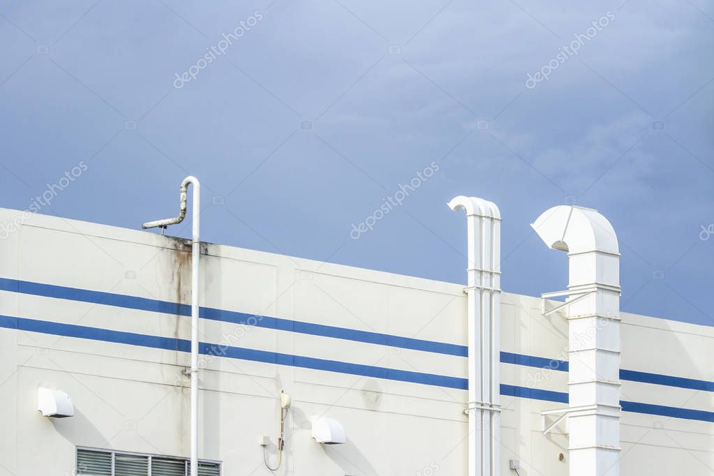 Several white ventilation vents are located next to the building