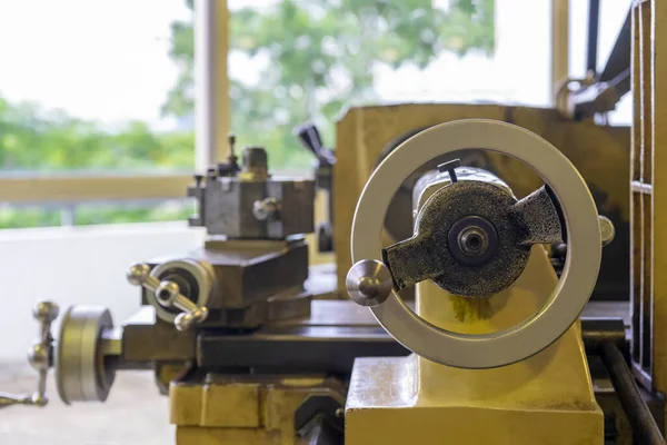 Machine work shop with grinder machine and bench Vise