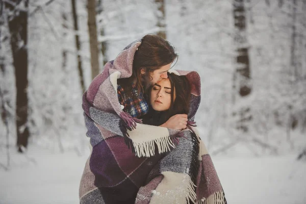 Loving couple in snowy winter forest — Stock Photo, Image