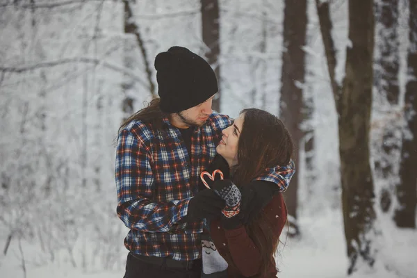 Loving couple in snowy winter forest — Stock Photo, Image