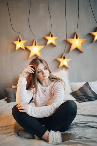 Schöne Frau sitzt zu Hause auf dem Bett — Stockfoto