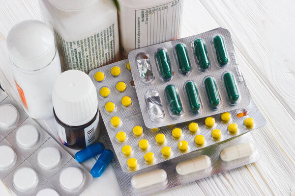 many colored medicine pills on white background