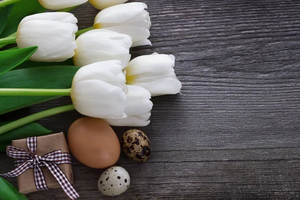 Boeket witte tulp bloemen met Pasen eieren op oude houten tabl Rechtenvrije Stockfoto's