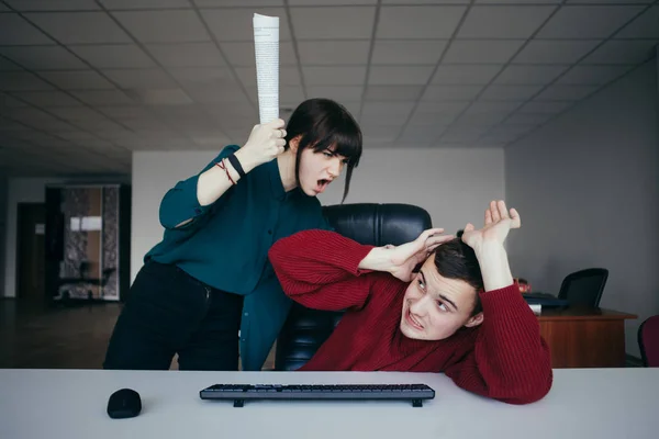Pracownik biurowy młodych i bardzo zła dziewczyna krzyczy na jego personel i chce uderzyć jego papierów wartościowych. Sytuacja w nowoczesnym biurze. — Zdjęcie stockowe