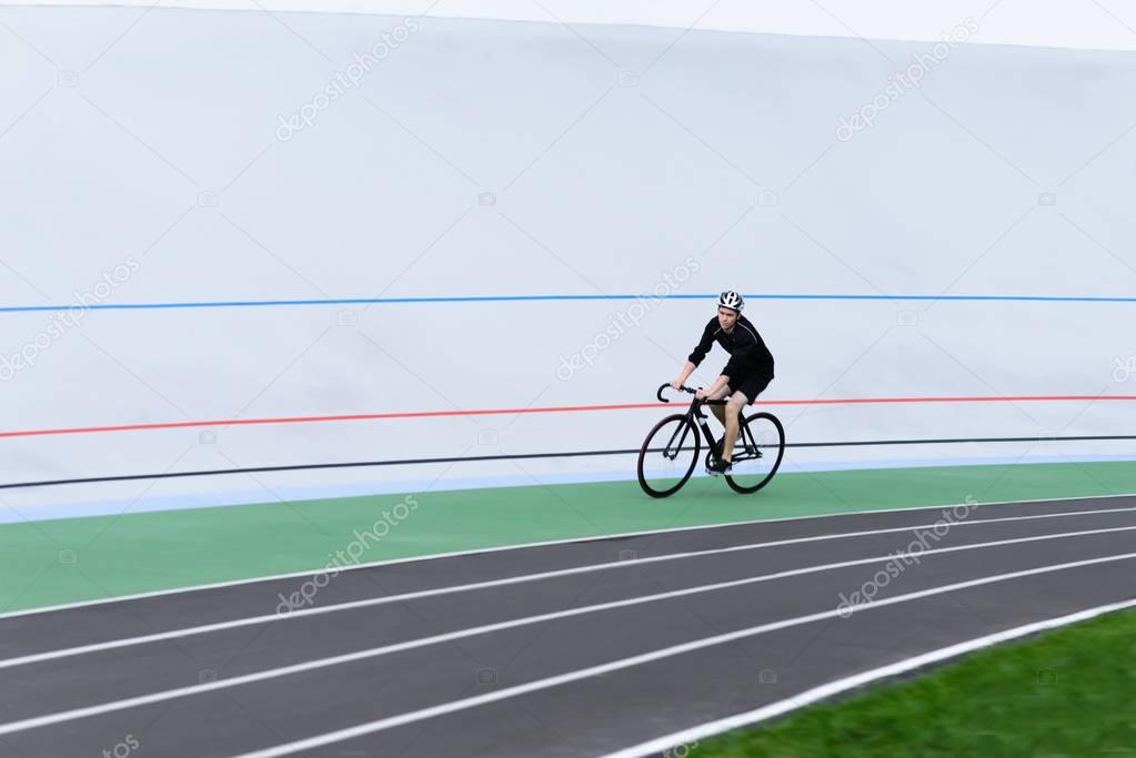 A cyclist is trained in the open air. Sports bike fixed. Athlete cyclist on velodrome