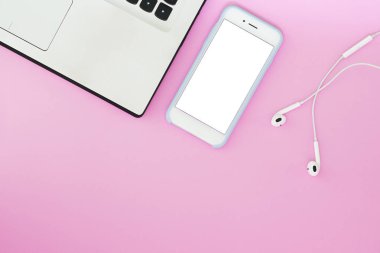 Beyaz bir ekran, bir dizüstü bilgisayar ve pembe bir arka plan üzerinde kulaklık ve metin için bir yer ile bir telefon. Düz yatıyordu Gadget'ı düzen