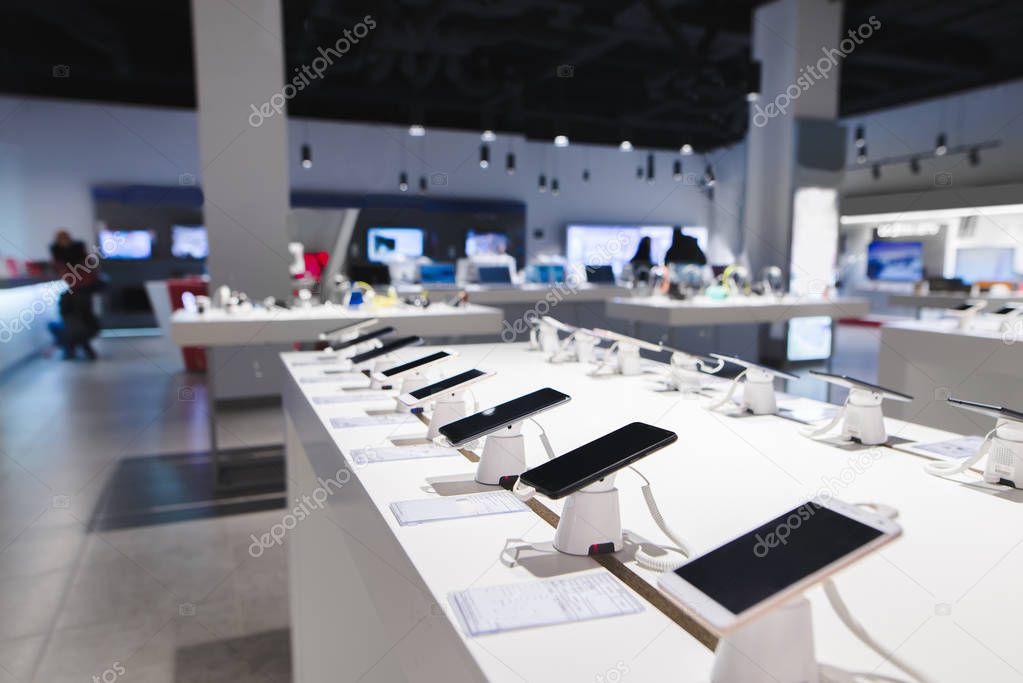 Many smartphones are on the table in the technology store. Buyin