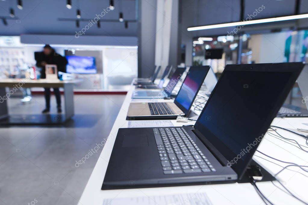 Laptops on the table in the electronics store. The department of