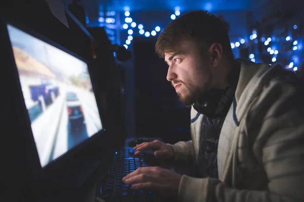 Портрет сфокусированного геймера во время игры дома за компьютером . — стоковое фото