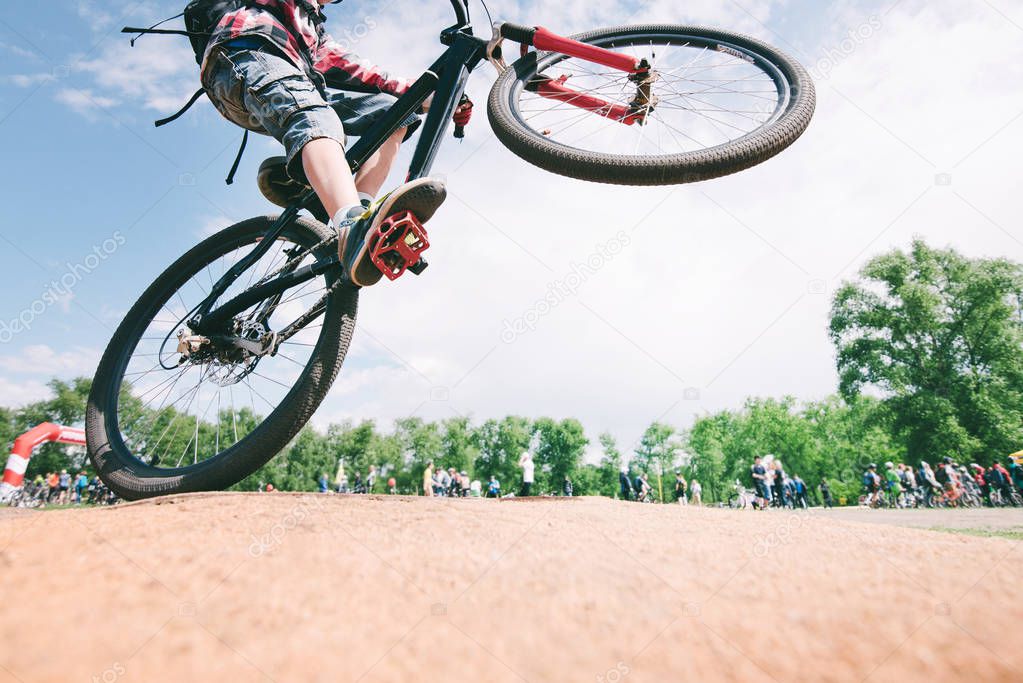 Tricks on the bike. A young man jumps on a mountain bike. Cycling Sports Concept.