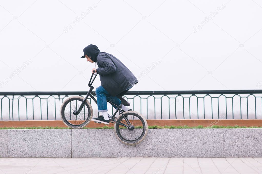 BMX freestyle. BMX rider slides on a bike on the bench. Street culture