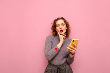 Portrait of pensive lady in casual clothes on pink background, i