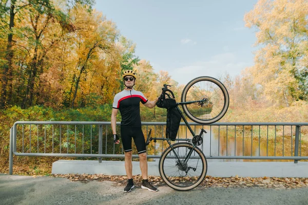 Cyclist Athlete Stands Bicycle Hands Bridge Autumn Landscape Lake Looks — Stock Photo, Image