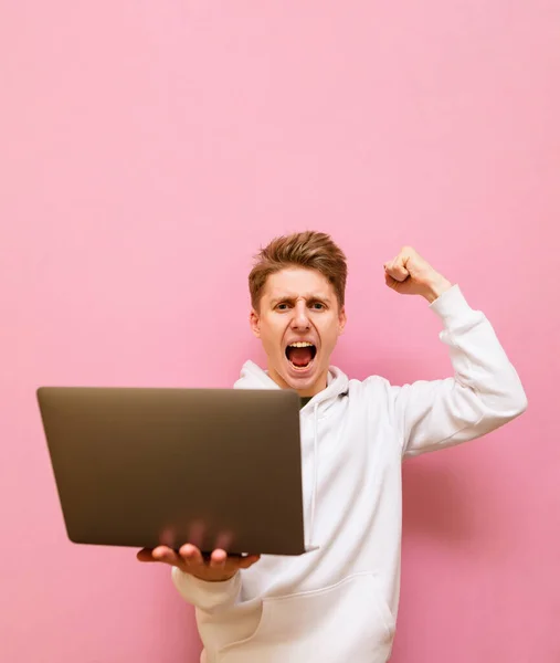 Emotional Guy Rejoices Victory Laptop His Hands Looks Camera Shouts — Stock Photo, Image