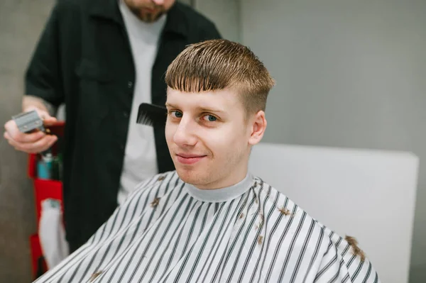 Closeup Portrait Cheerful Young Barbshop Customer Sitting Chair Cutting Hairdresser — Stock Photo, Image