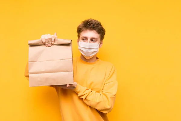 Handsome Young Man Stands Package Food Delivery His Hands Medical — Stock Photo, Image