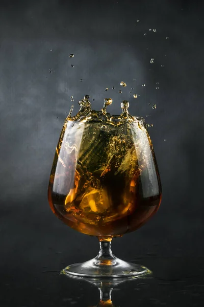 Spray in cognac glass — Stock Photo, Image