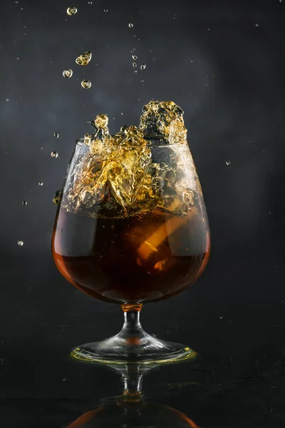 Spray in cognac glass — Stock Photo, Image