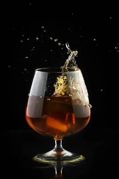 Spray in cognac glass — Stock Photo, Image