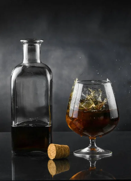 Spray in cognac glasss — Stock Photo, Image