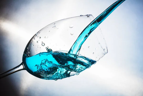 Spray colored water in a glass — Stock Photo, Image