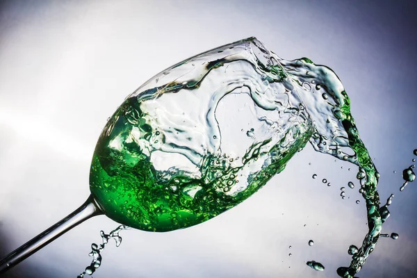 Spray colored water in a glass — Stock Photo, Image