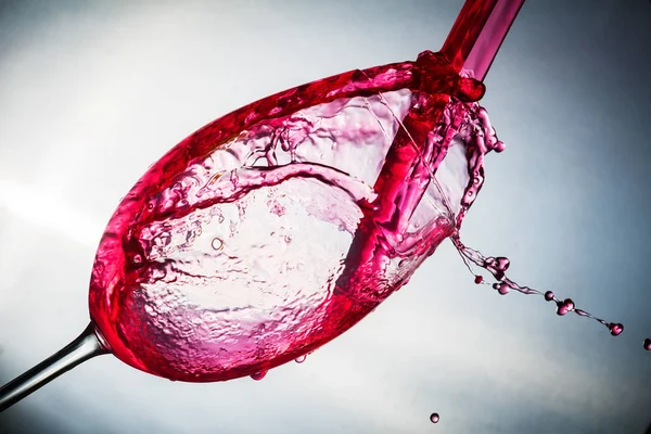 Spray colored water in a glass — Stock Photo, Image