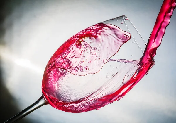 Spray colored water in a glass — Stock Photo, Image