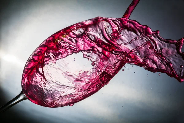 Spray colored water in a glass — Stock Photo, Image