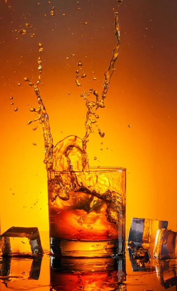 Large Glass Whiskey Spray Photographed Black Glass Reflection Royalty Free Stock Images