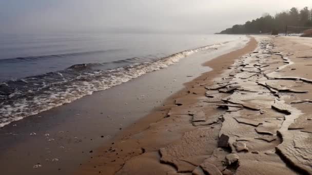 Sandy shore covered with ice. Beautiful dawn. Morning fog. — Stock Video