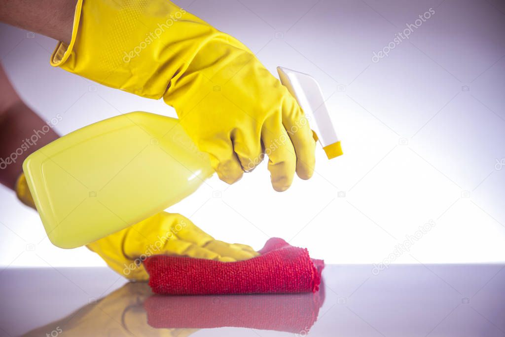 Hhands cleaning surface with gloves