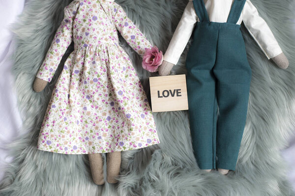 Closeup of handmade rag dolls. Easter handmade bunny dolls placed on fur 