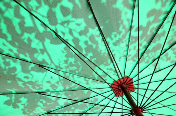 Green umbrella and shadows — Stock Photo, Image