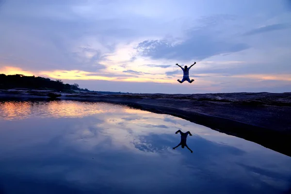 Man jump on rock formation — Stock Photo, Image