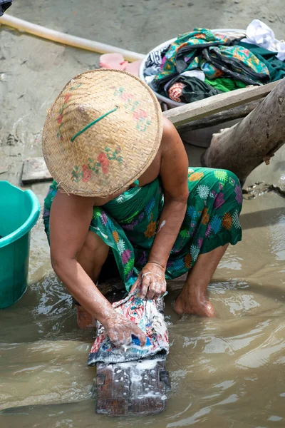 Life along the river, people wash clothes.