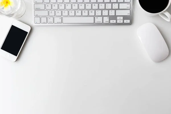 Modern white office desk top table with computer laptop, cup of coffee, notebook and other supplies. Top view with copy space on white background. Top view, flat lay.