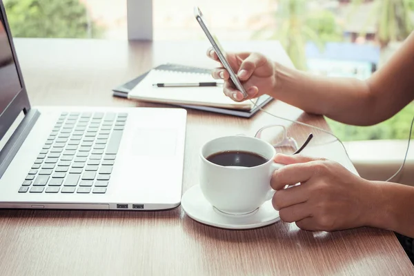 Close Up of woman hands using mobile phone and laptop computer with blank copy space screen for your advertising text message or content business in the Vintage effect. — Stock Photo, Image