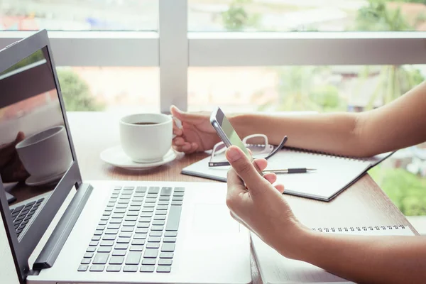 Close Up of women hands using mobile phone and laptop computer with blank copy space screen for your advertising text message or content business in the Vintage effect. — Stock Photo, Image