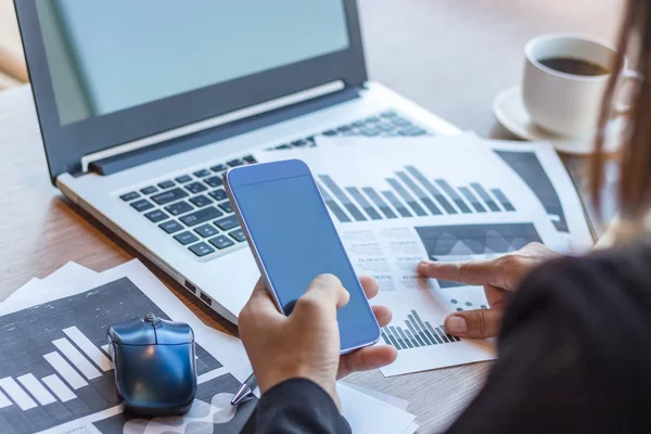 Close Up businessmen working at a coffee shop with a document with a smartphone and a laptop computer. — Stock Photo, Image