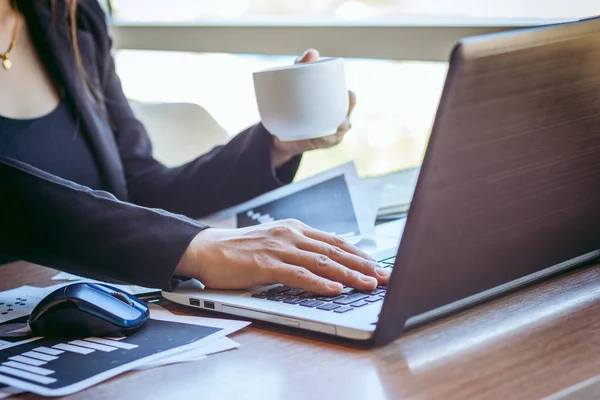 Close Up businessmen working at a coffee shop with a document with a smartphone and a laptop computer. — Stock Photo, Image