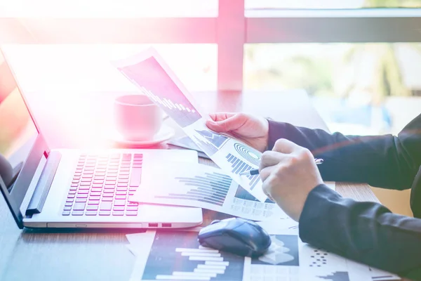 Close Up businessmen working at a coffee shop with a document with a smartphone and a laptop computer. — Stock Photo, Image