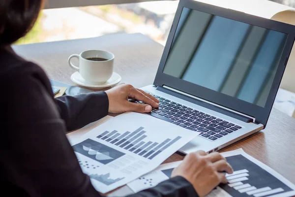 Close Up businessmen working at a coffee shop with a document with a smartphone and a laptop computer. — Stock Photo, Image