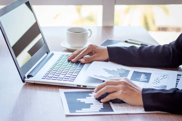 Close Up businessmen working at a coffee shop with a document with a smartphone and a laptop computer. — Stock Photo, Image