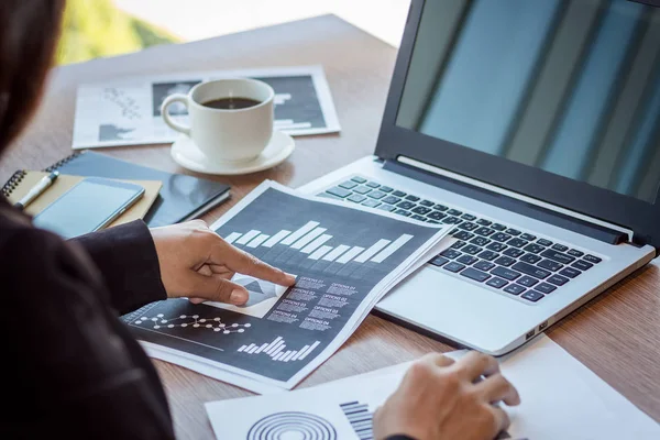 Close Up businessmen working at a coffee shop with a document with a smartphone and a laptop computer. — Stock Photo, Image